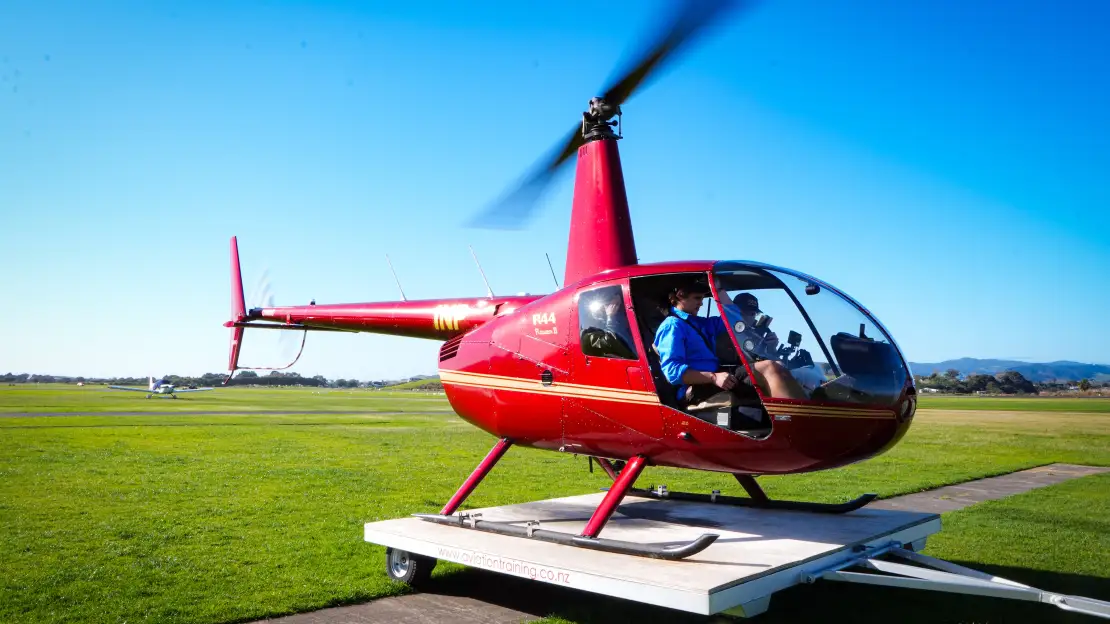 Red helicopter used for scenic flights over the Bay of Plenty region